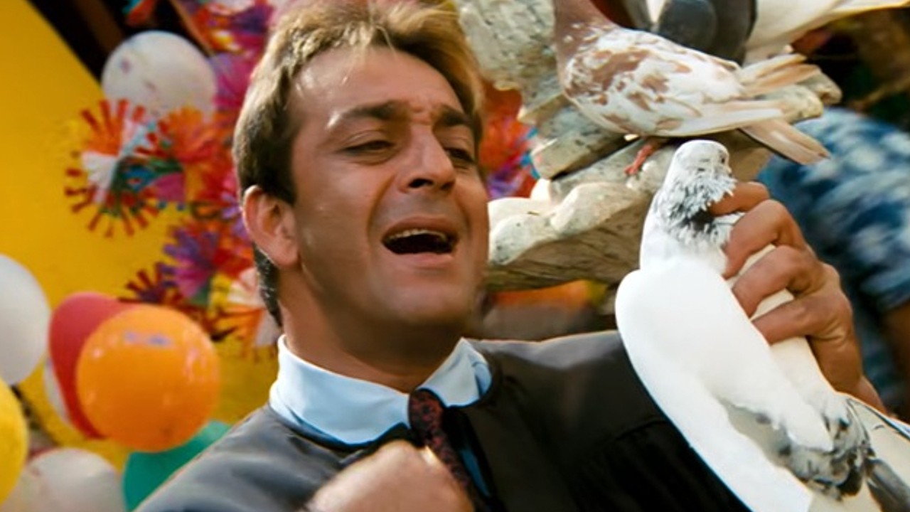 Ever Wondered Why Munna Bhai’s 'M Bole Toh' Song Mixed English With Tapori Slang? The Reason Is Secretly Connected To Shah Rukh Khan! 1 A close-up of Sanjay Dutt in his iconic role from Munna Bhai M.B.B.S., a character originally tailored for Shah Rukh Khan.
